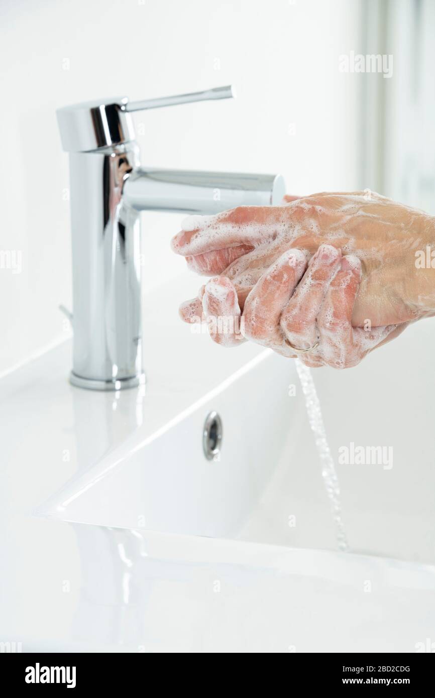 washing hands with soap under running water Stock Photo - Alamy
