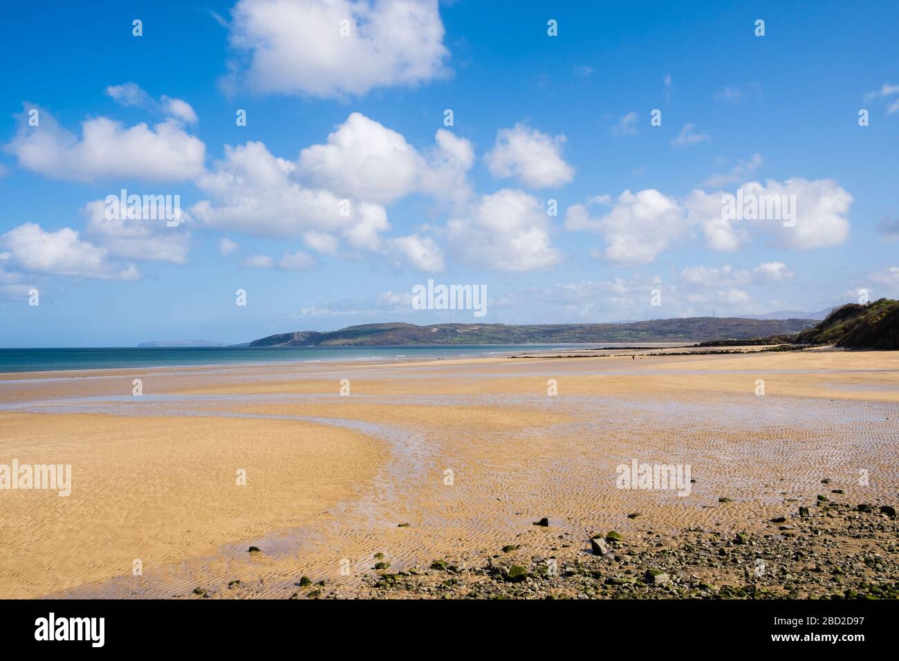 Large expanse of quiet beach during Covid-19 lockdown on sunny day in April 2020. Benllech Anglesey Wales UK Stock Photo