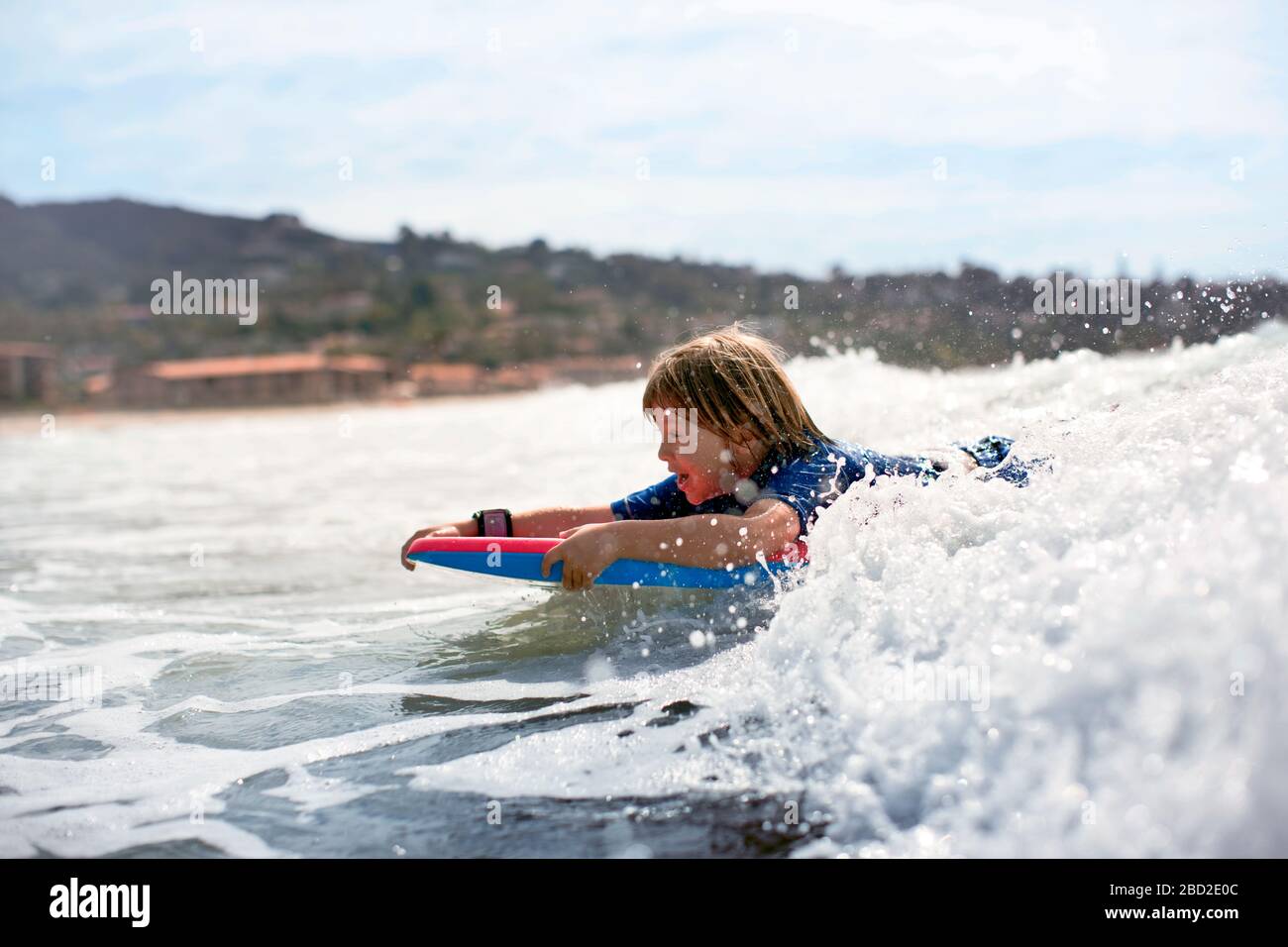 Boy riding a wave on boogie board Stock Photo Alamy