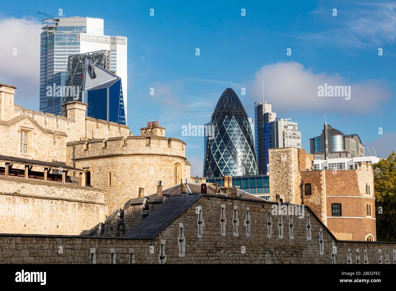 Old and New - Medieval Tower of London with the Gherkin and modern buildings beyone, London, England, UK Stock Photo