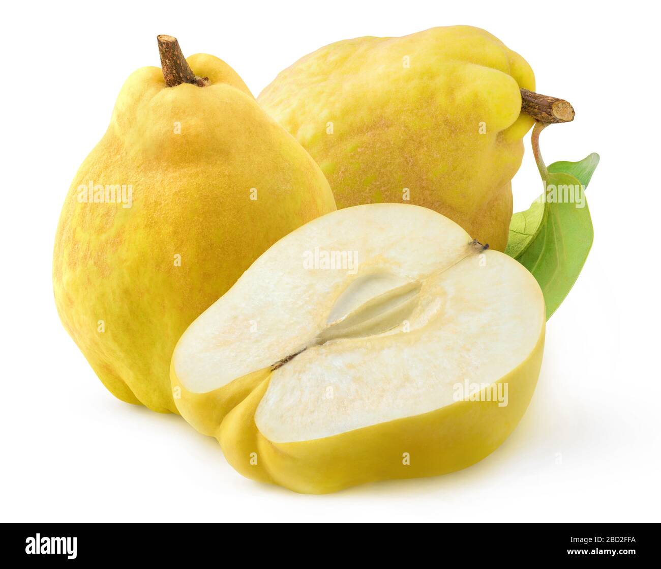 Isolated quince. Two whole quince fruits with leaves and a half isolated on white background Stock Photo
