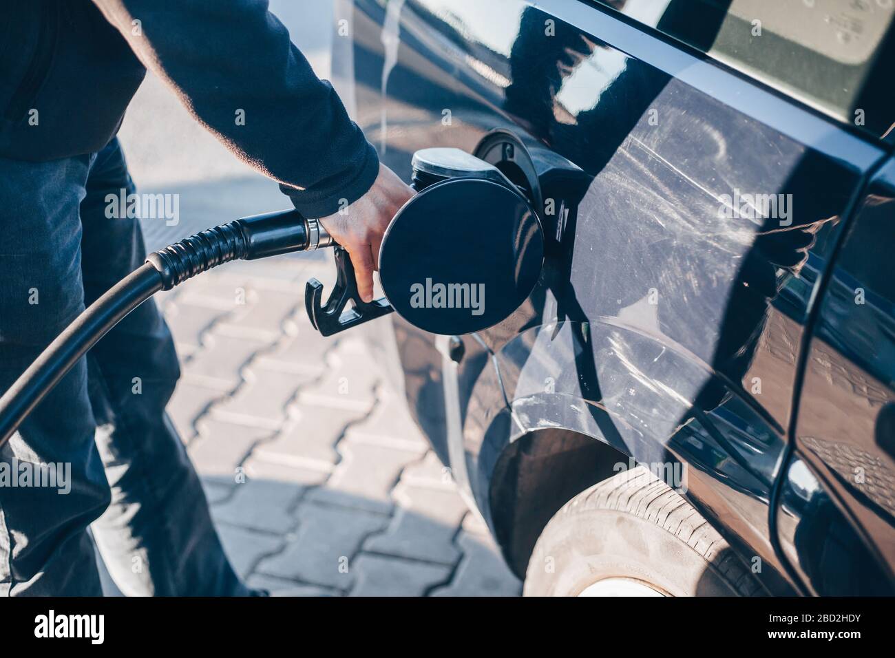 Man refueling a car during low fuel rates, fuel prices, transport concept Stock Photo