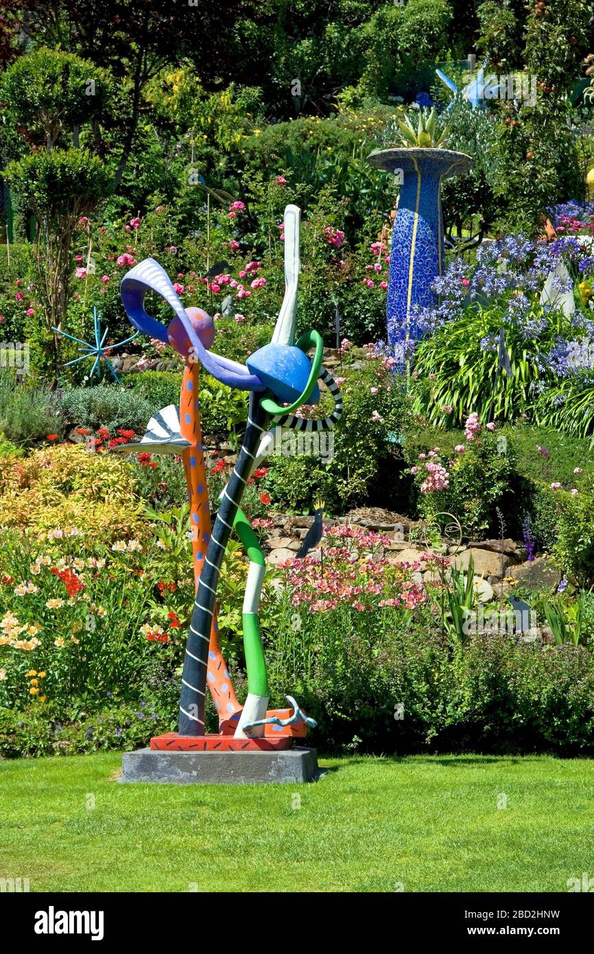 garden scene; whimsical sculpture; flowers; grass; shrubs, colorful