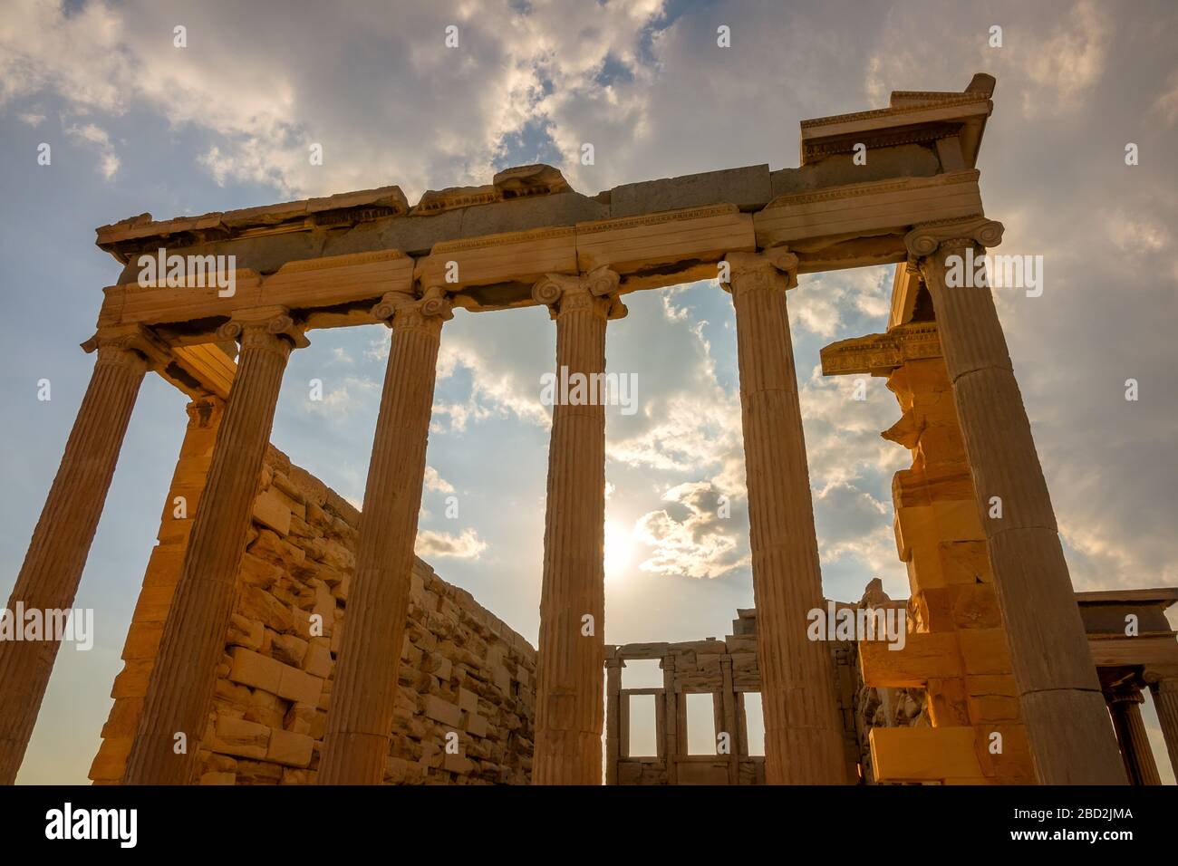 Greece. Part of the facade of an ancient temple and the sunbeams in Athens Stock Photo