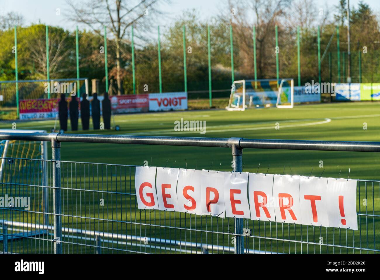 Bornheim, North Rhine-Westphalia, Germany - April 4, 2020: Soccer field closed due to corona virus, covid-19 pandemic. Sign with German lettering Stock Photo