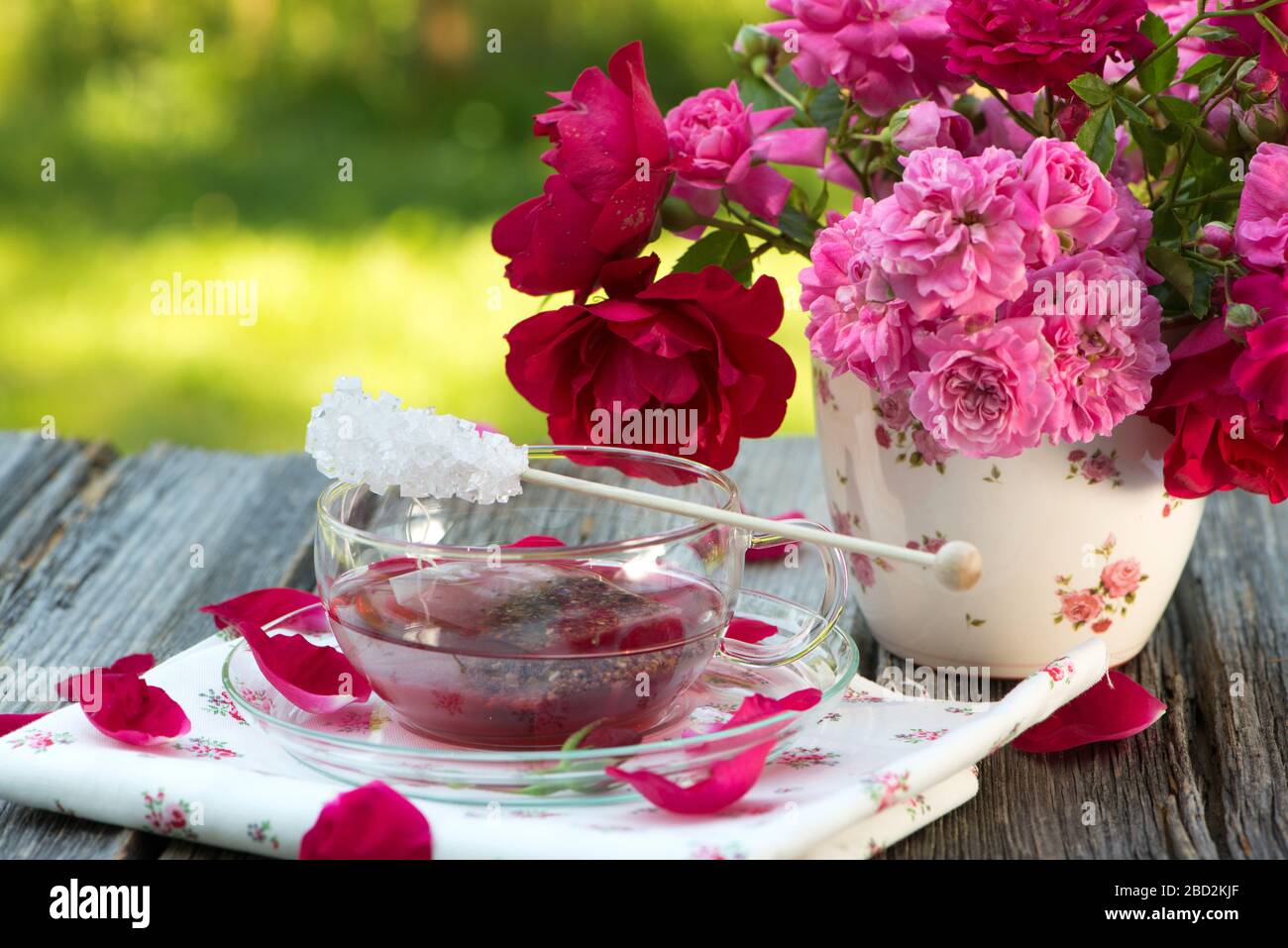 Rose tea with fresh roses on wooden background Stock Photo - Alamy