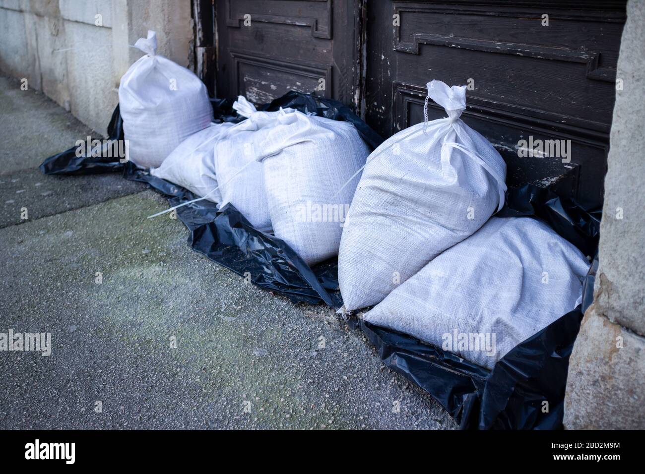 Sandbags stacked in front of doors to protect against flooding of river or sea Stock Photo Alamy