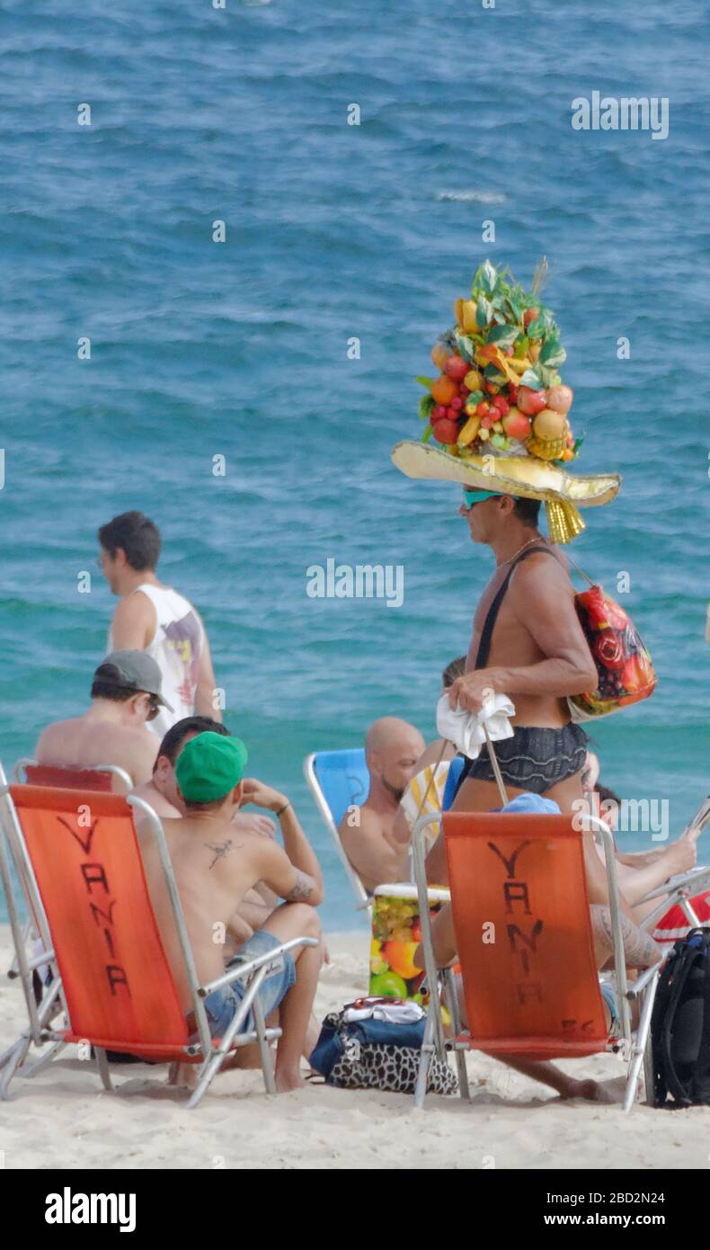 Beach goer in a fruit hat, Ipanema Beach, Rio De Janeiro, Brazil Stock Photo