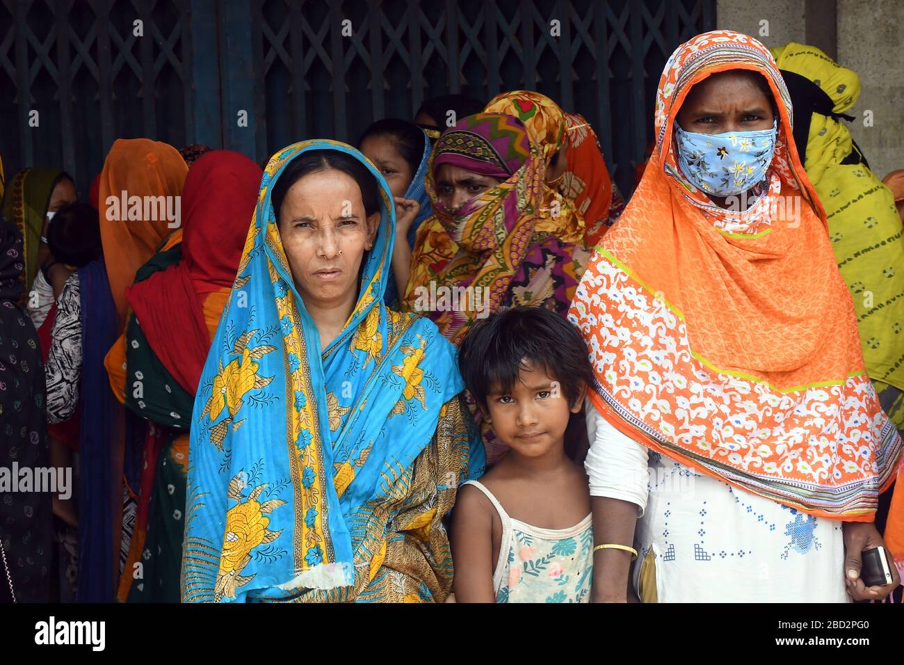 Bangladeshi homeless people wait in a queue to get aid during the nationwide lockdown imposed as a measure to prevent the spread of COVID-19, in Dhaka Stock Photo