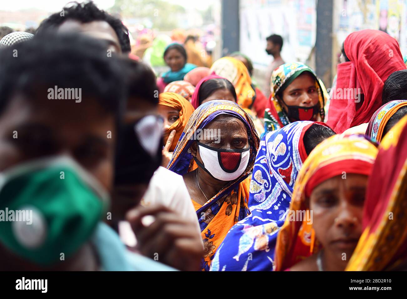 Bangladeshi homeless people wait in a queue to get aid during the nationwide lockdown imposed as a measure to prevent the spread of COVID-19, in Dhaka Stock Photo