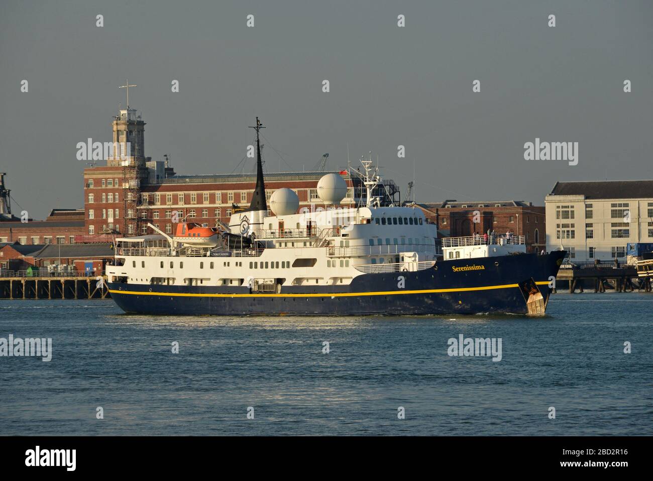 SERENISSIMA departing from Portsmouth Harbour with the historic dockyard buildings beyond. Stock Photo