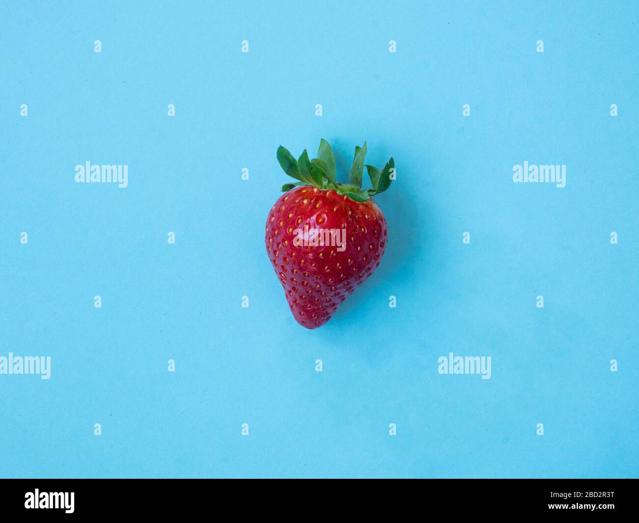 Top view of strawberry on blue background Stock Photo - Alamy
