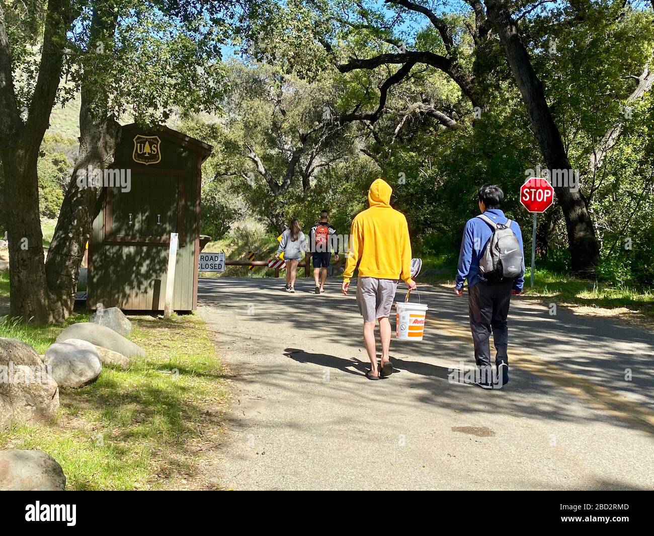 Santa Barbara, California, USA. 4th Apr, 2020. Over fifty adults and children come splashing, falling, jumping through the muddy water at the ''First Crossing: Day Use Area'' in the Los Padres National Forest within a 30 minute period, during the height of the Corona Virus outbreak. They crossed the water one after the other, without pause, on foot, bikes, kayaks and their parent's back, alone or in groups. Some are maintaining social distancing, many not - no one in masks. Credit: Amy Beth Katz/ZUMA Wire/Alamy Live News Stock Photo