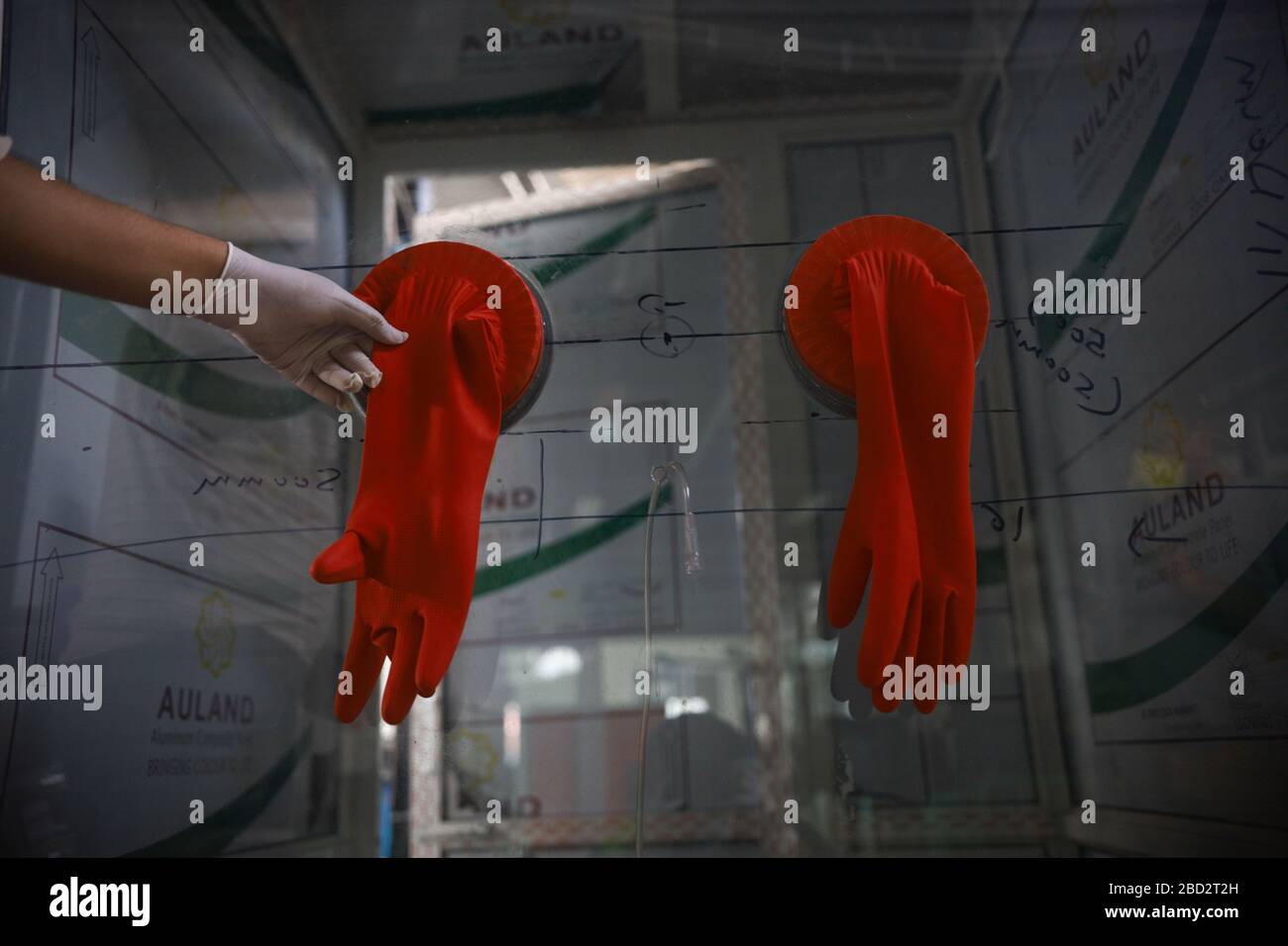 Kathmandu, Nepal. 06th Apr, 2020. A man checking rubber gloves used in