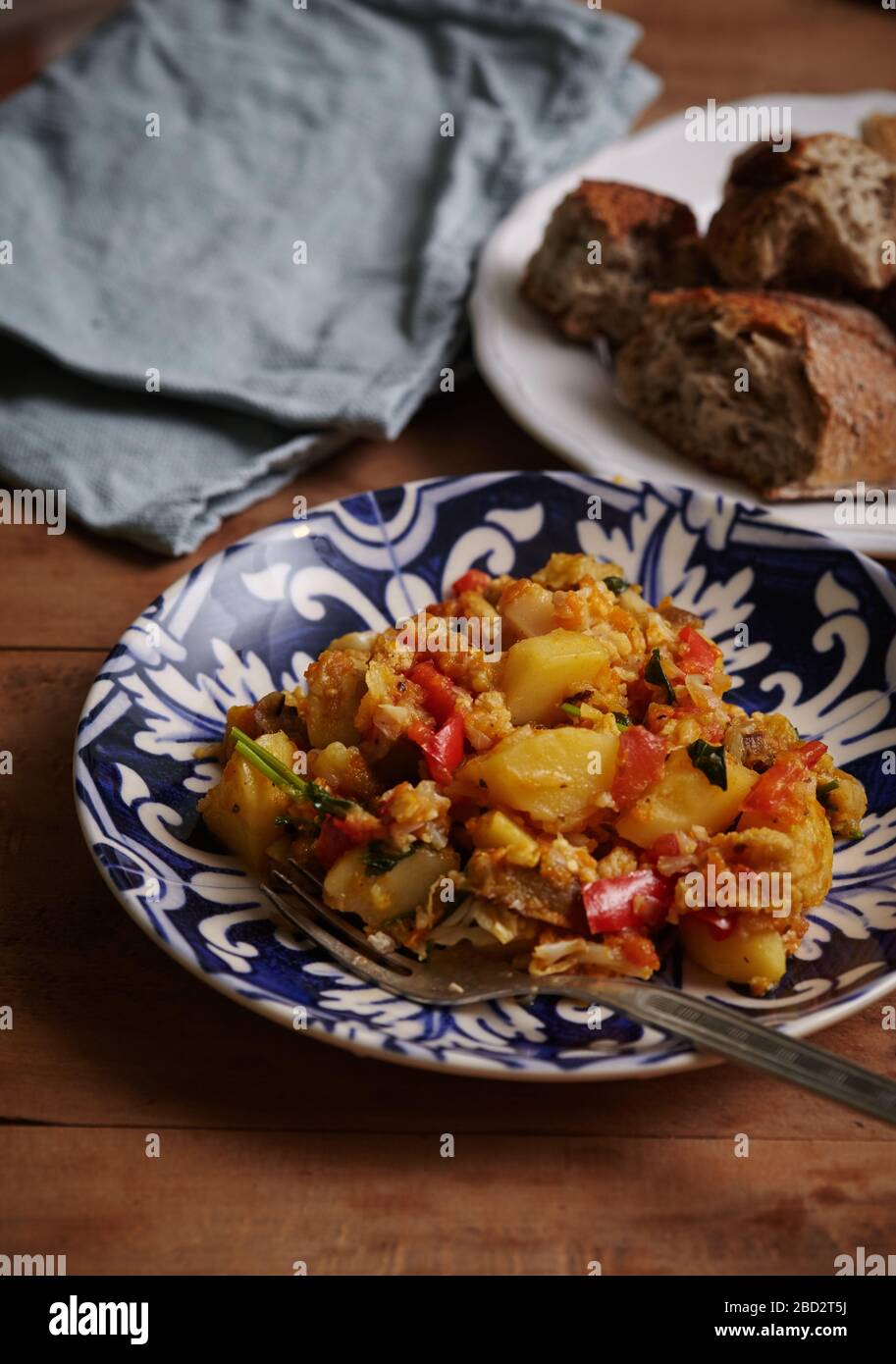 Delicious stew of potatoes, peppers, cauliflower, carrots, onions and green parsley. Stock Photo