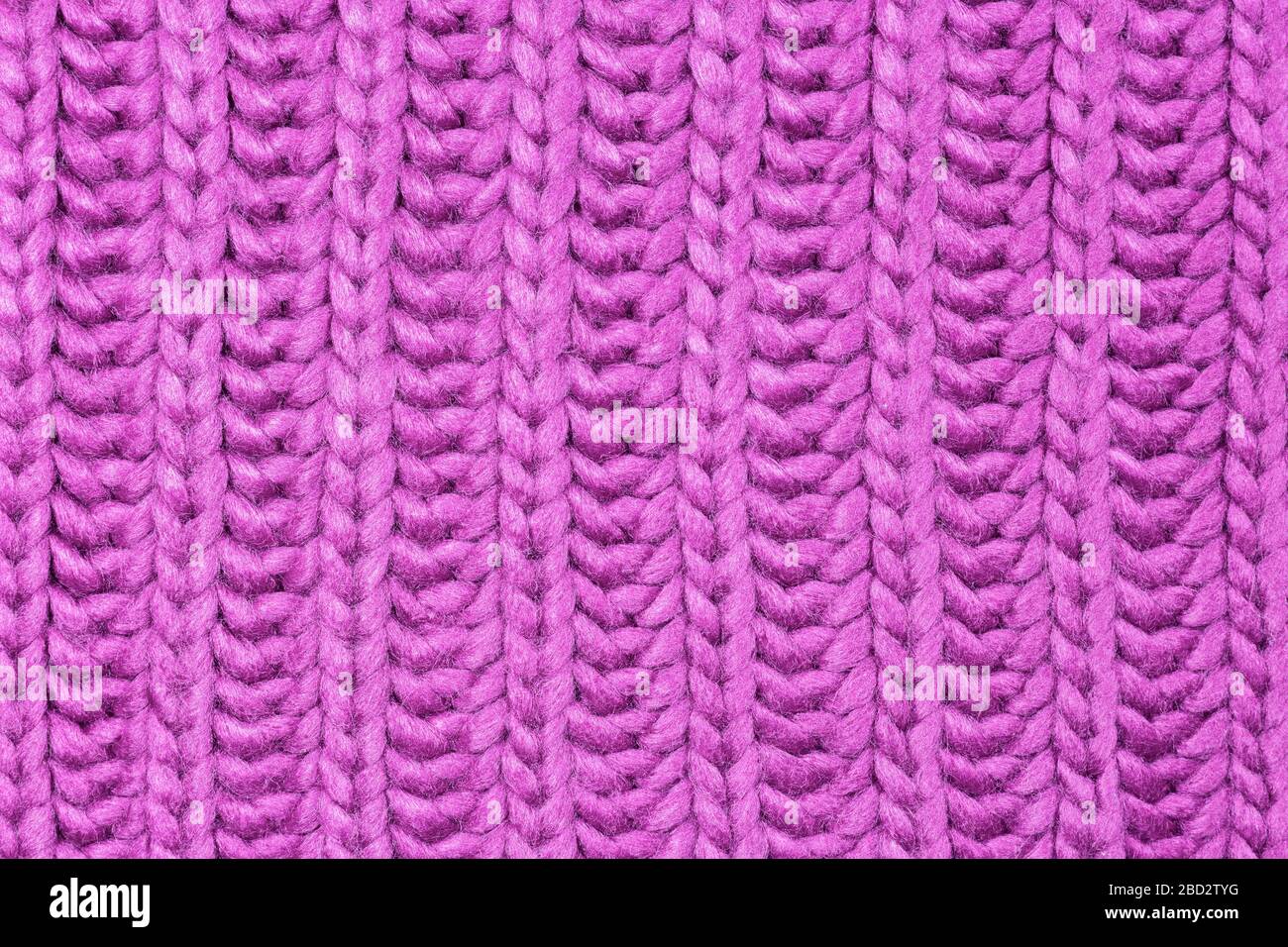 Close-up photo of pink knitted sweater background, texture with copy space. Good pattern for design. Stock Photo
