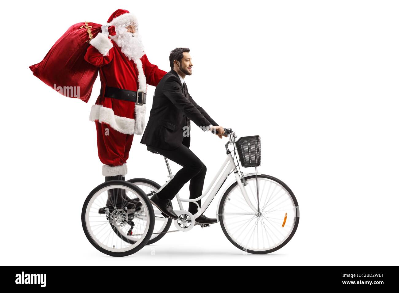 Businessman riding a tricycle with Santa Claus isolated on white background Stock Photo