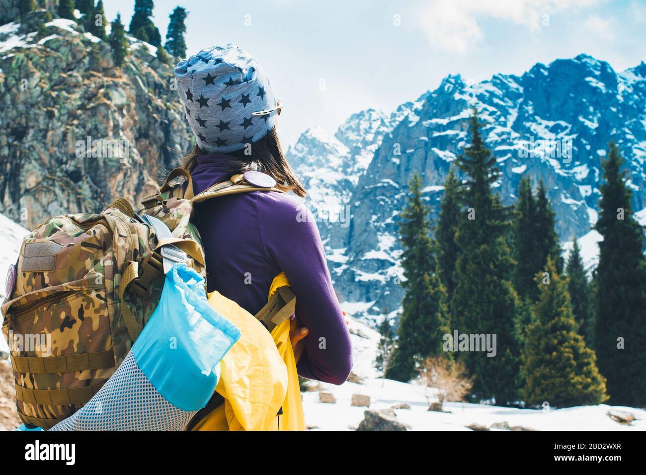Traveling girl with backpack hiking in the mountains, freedom concept ...