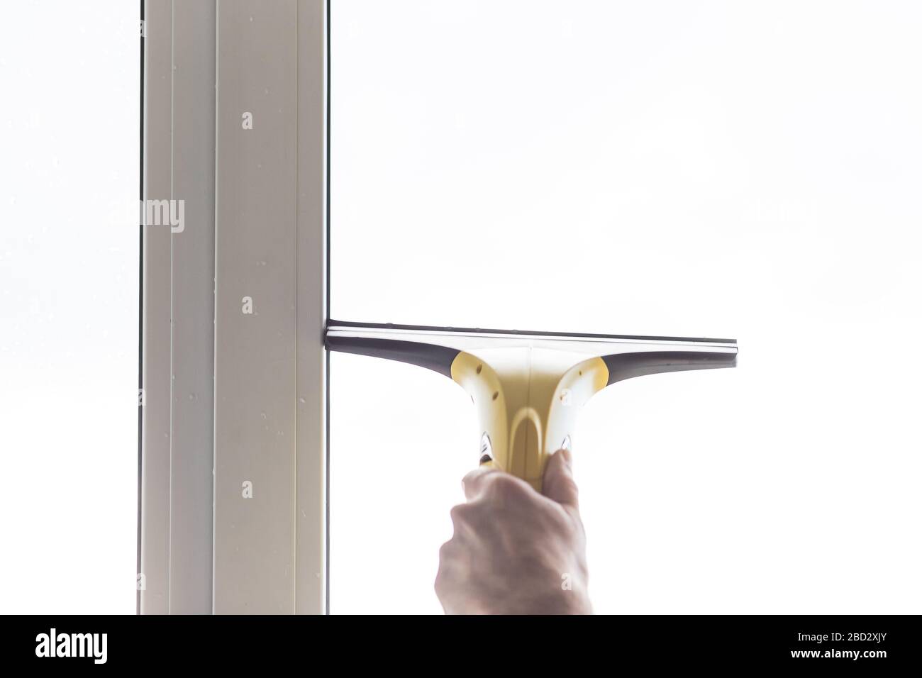 Cleaning windows with electric vacuum cleaner. Spring house cleaning