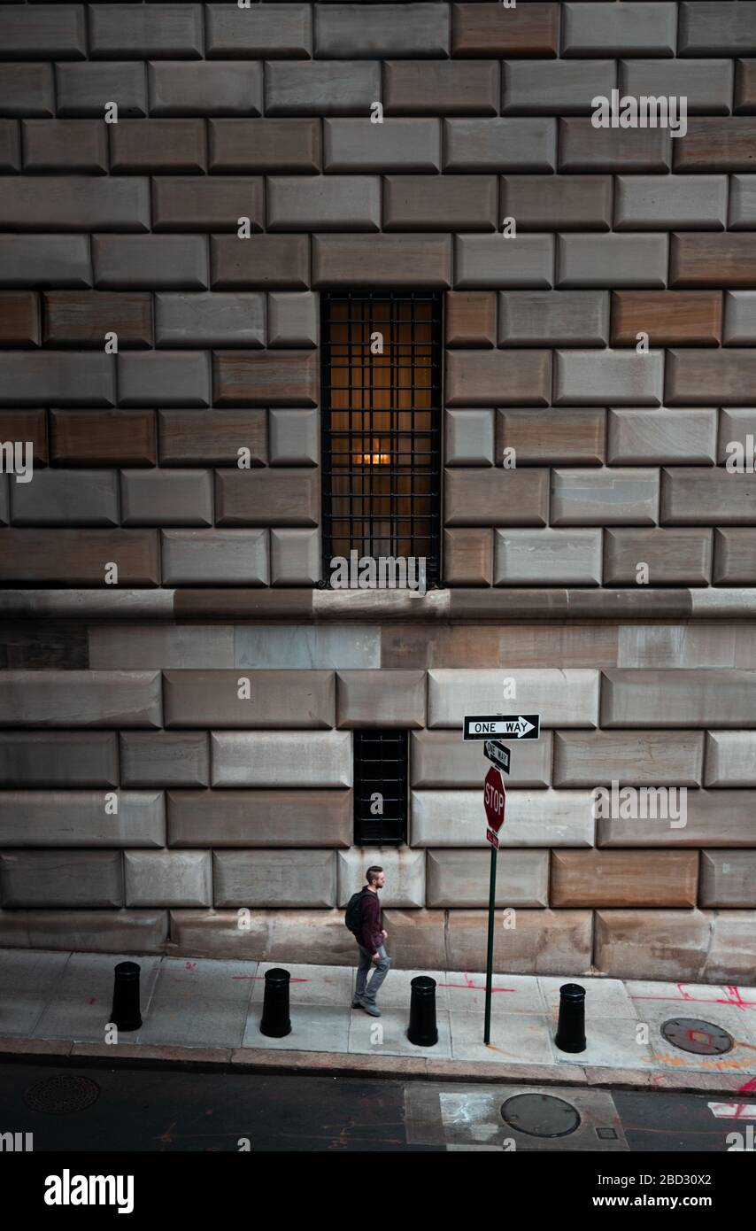 Man walking alone in New York financial district during Corona outbreak Stock Photo