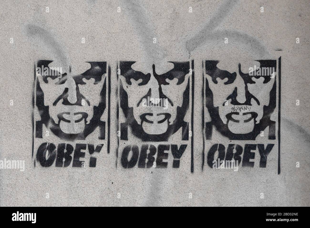 Stencil graffiti of Viktor Orban with the word obey on a wall Stock Photo