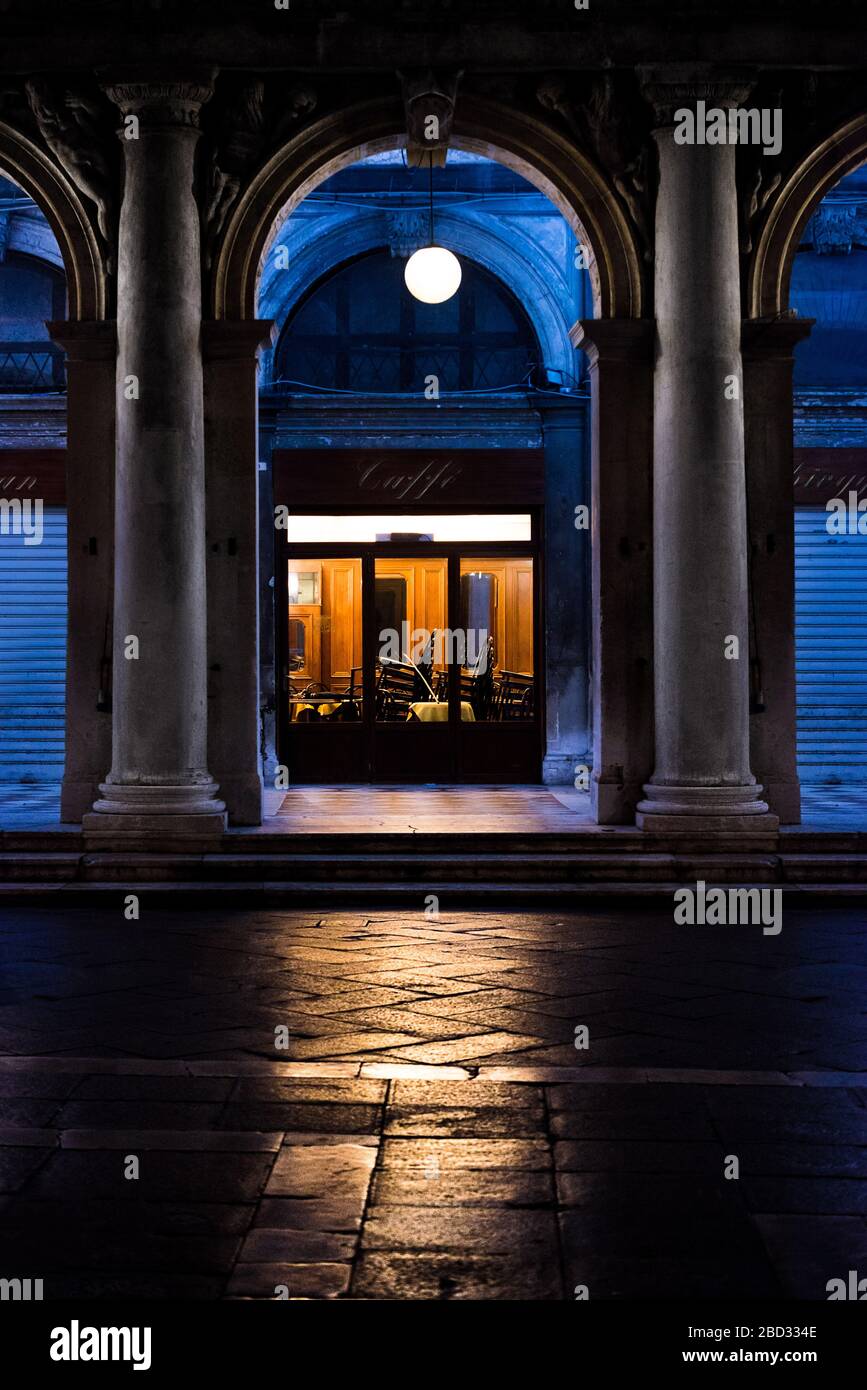 Symmetrical night shot of an historical bar in Saint Mark's square closing down Stock Photo