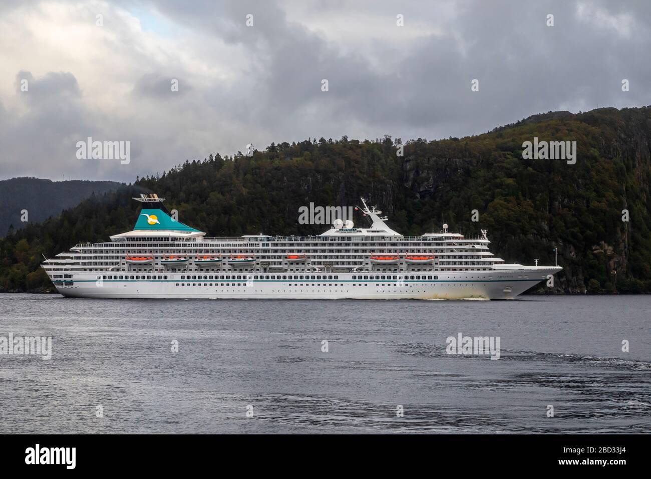 Cruise ship Artania (built 1984) at Byfjorden, departing from port of Bergen, Norway. A grey and rainy day. Stock Photo