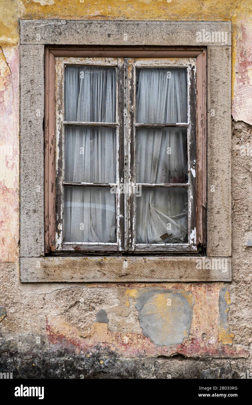 Old window and broken glass with curtains. Stock Photo
