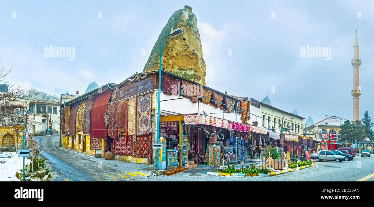 GOREME, TURKEY - JANUARY 17, 2015: Panorama of old rug market (bazaar), with large amount of hanging carpets, traditional kilims, souvenirs and differ Stock Photo