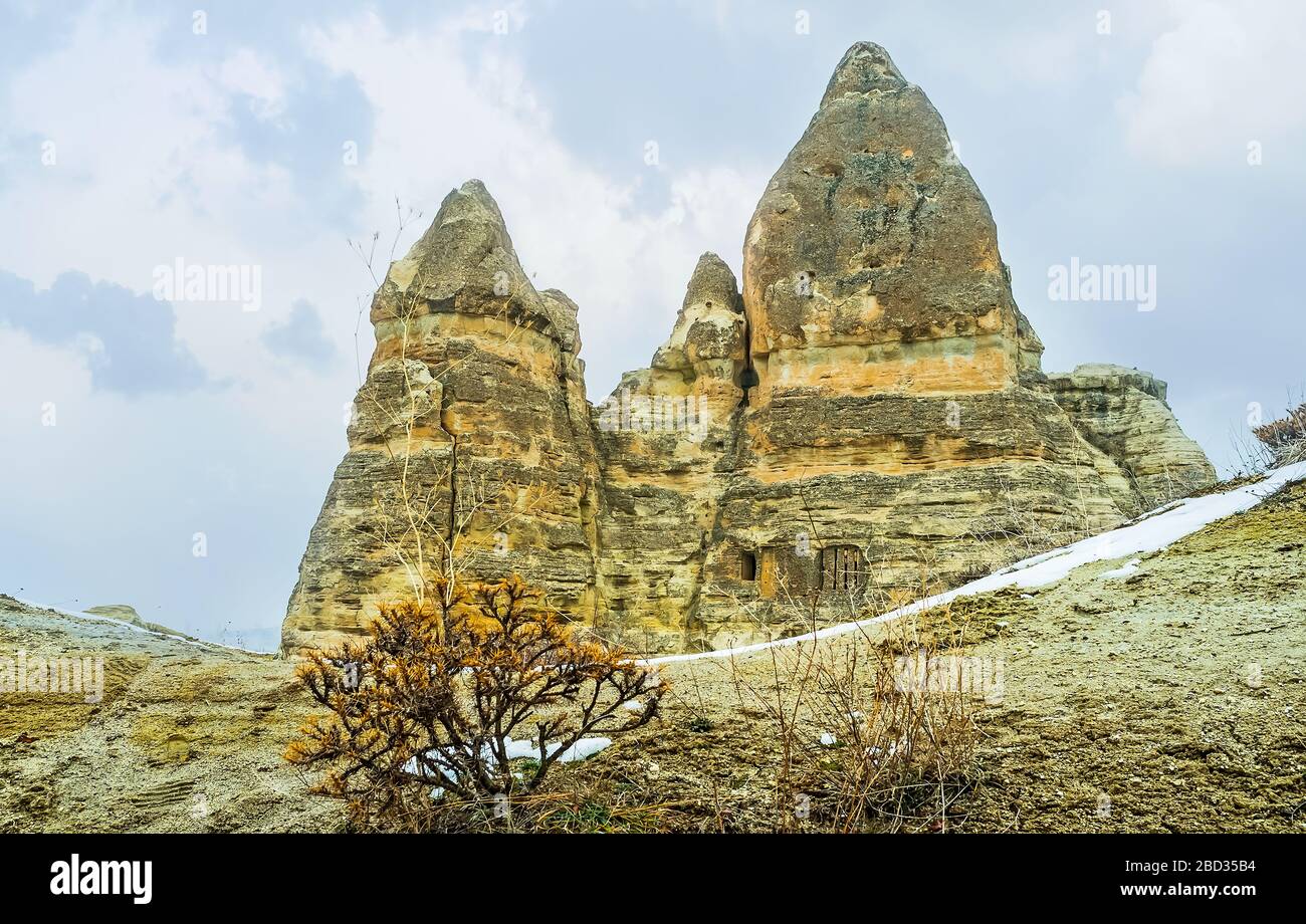 Cappadocian rocks with preserved cells, cut in them and remains of weathering, shaped these formations, Turkey Stock Photo