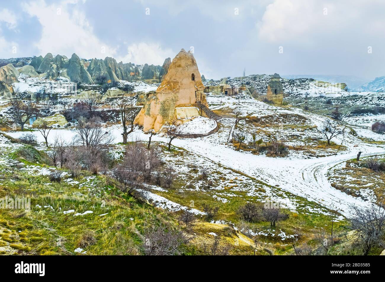 The landscape of winter  Cappadocia with El Nazar Kilise or Evil Eye Church, located in large yellow rock, Turkey Stock Photo