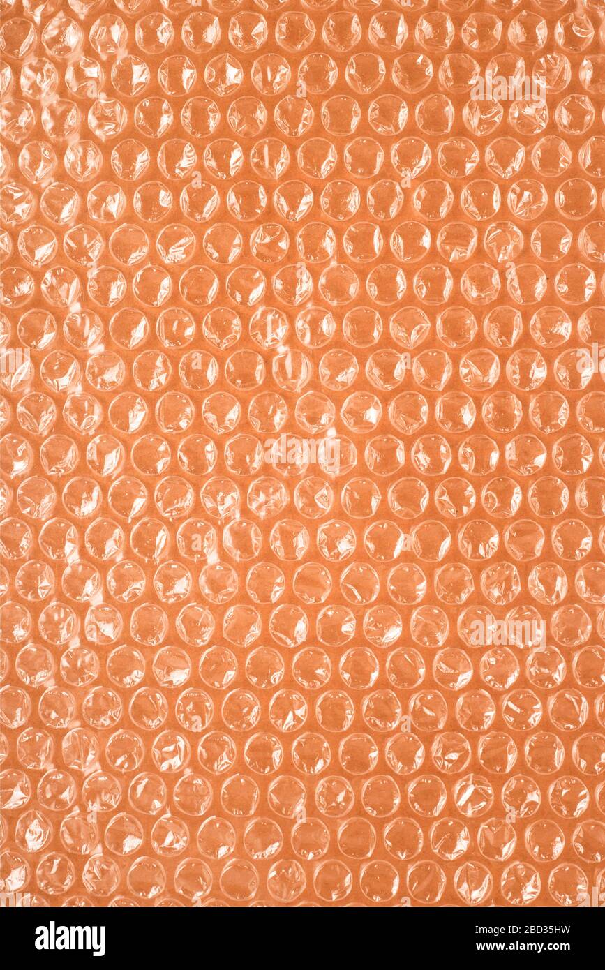 Air bubble packaging on a brown background. Not environmentally friendly plastic material. Environmental damage concept. Stock Photo