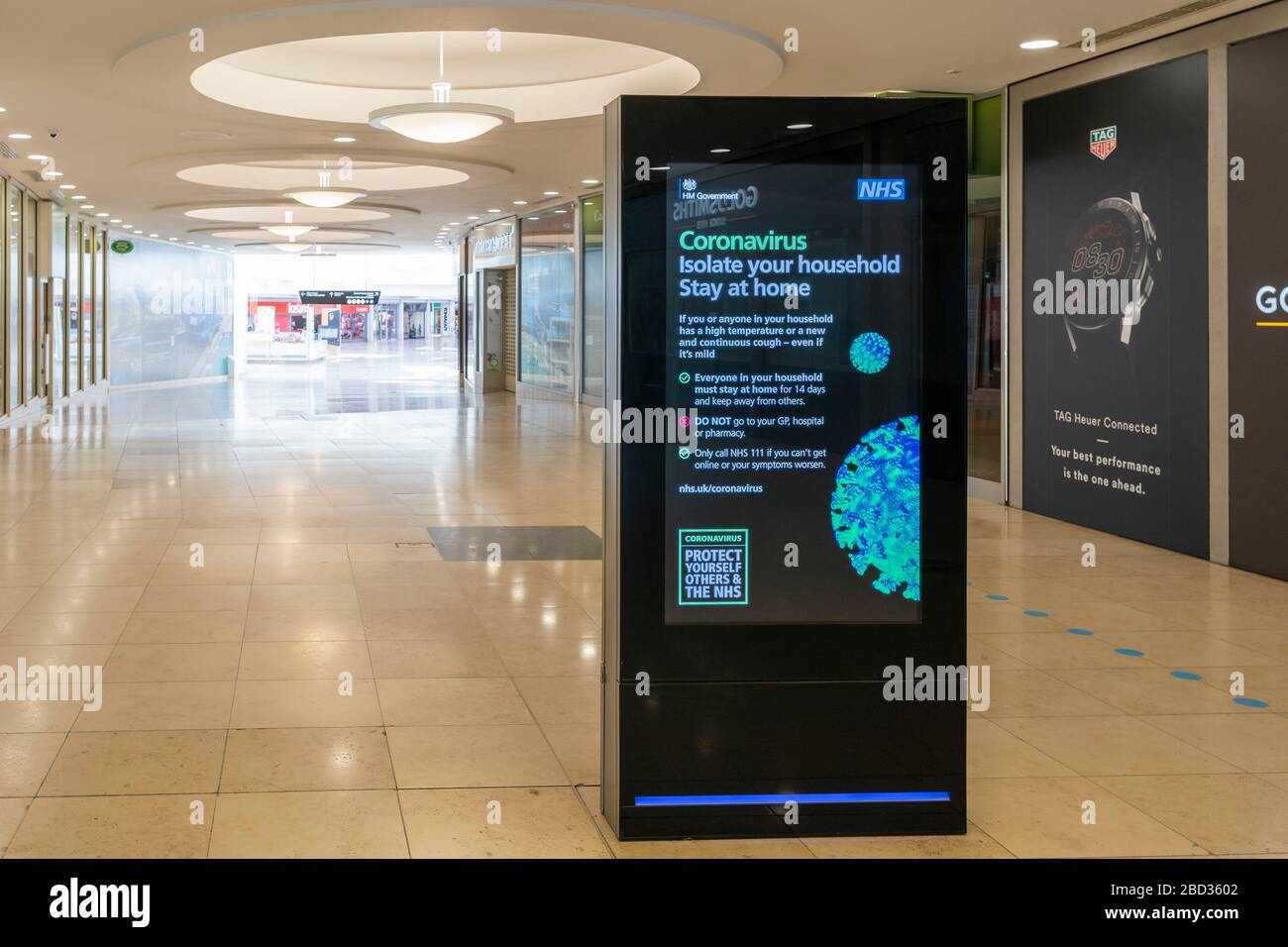 Official HM Government warning notice about Coronavirus Covid-19 is displayed in an empty Festival Place shopping centre, Basingstoke, UK, April 2020 Stock Photo