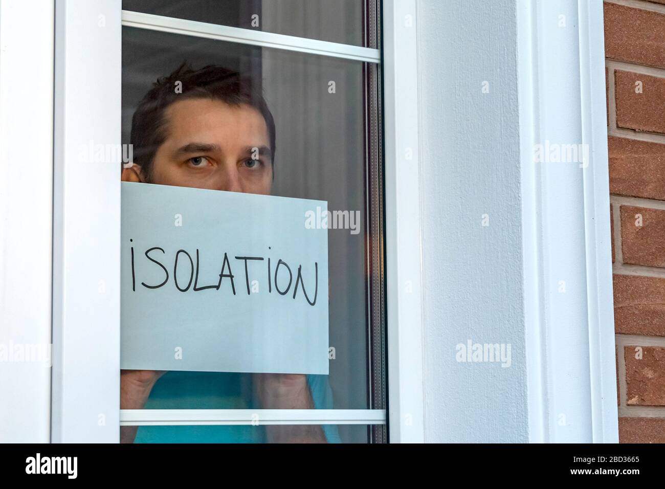 Man holds a sign that says - ISOLATION. Quarantine Stock Photo