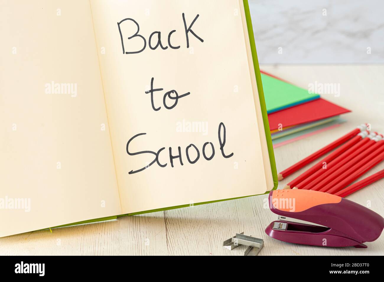 Notepad and stapler on wooden table. Concept back to school. Stock Photo