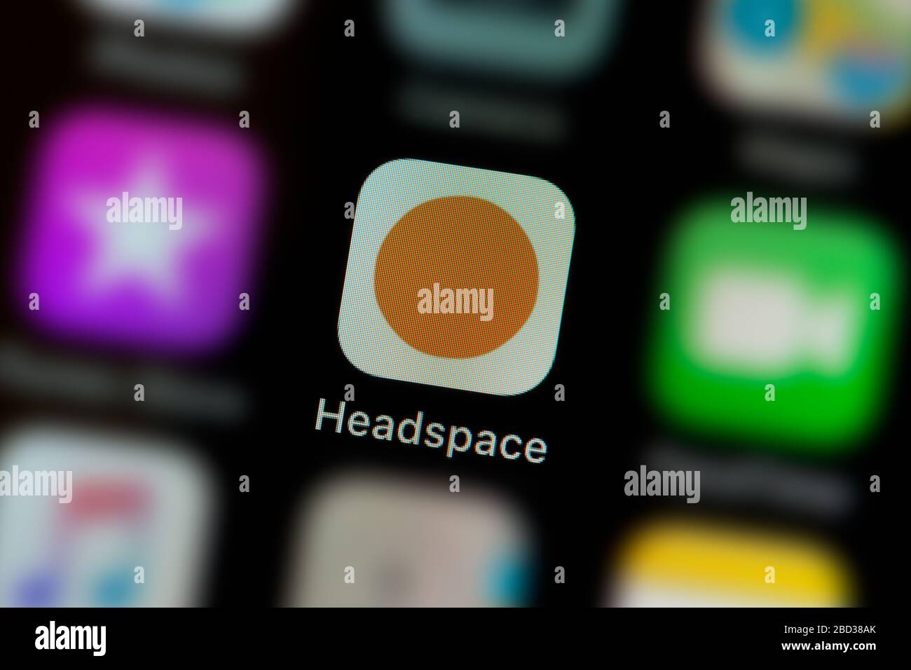 A closeup shot of the Headspace app icon, as seen on the screen of a