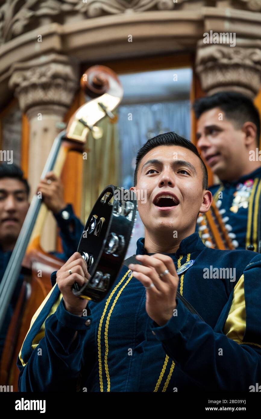 Troubadodours entertain a crowd in the market of Guanajuato, Mexico. Stock Photo