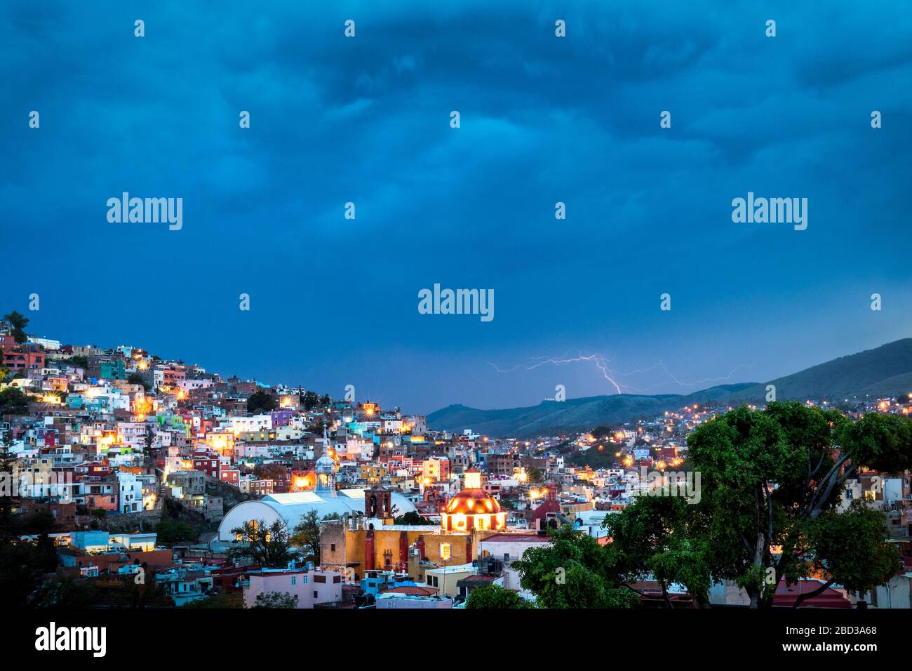 Lightning strikes in the distance over colonial Guanajuato, Mexico. Stock Photo