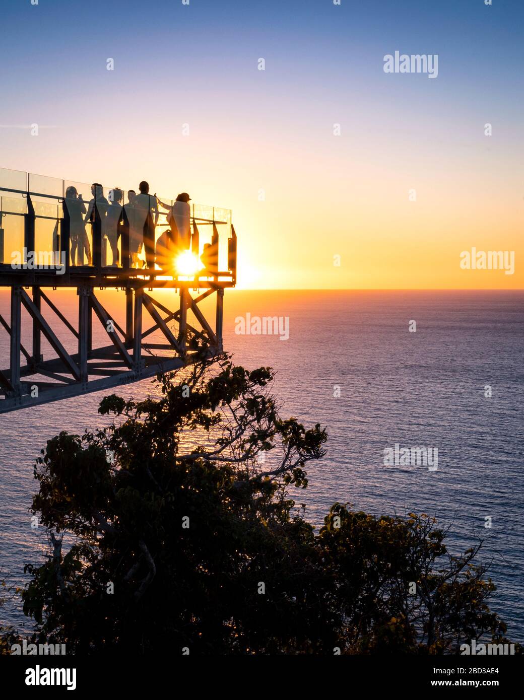 Tourists enjoy the sunset over the Pacific Ocean from the lighthouse lookout in Mazatlan, Sinaloa, Mexico. Stock Photo