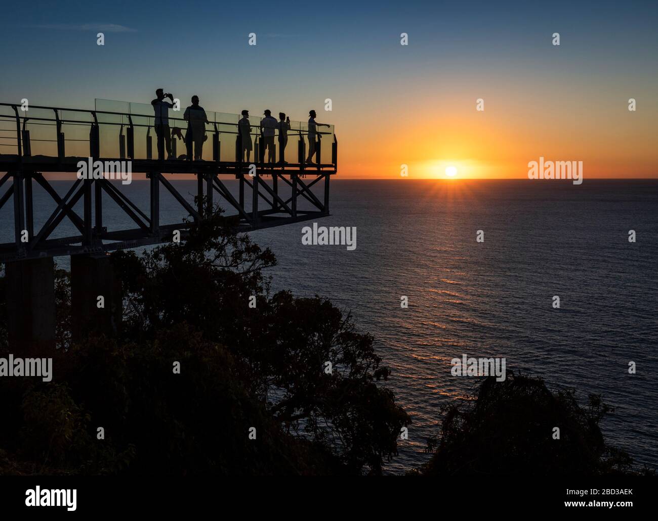 Tourists enjoy the sunset over the Pacific Ocean from the lighthouse lookout in Mazatlan, Sinaloa, Mexico. Stock Photo