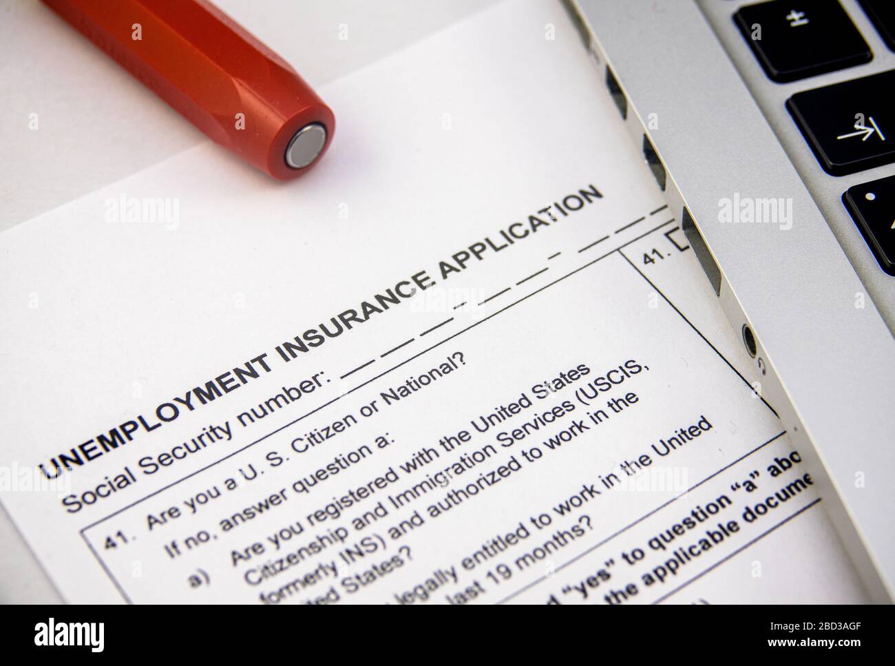 An Unemplyment Insurance Application Form Being Filled Out Due To The Coronavirus Pandemic Stock Photo