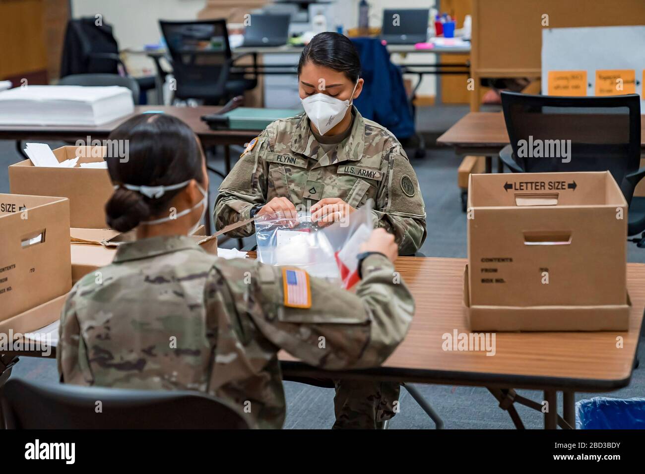 New York Army National Guard members assemble novel coronavirus specimen collection test kits at the State Department of Health Wadsworth Center April 4, 2020 in Albany, N.Y. Stock Photo