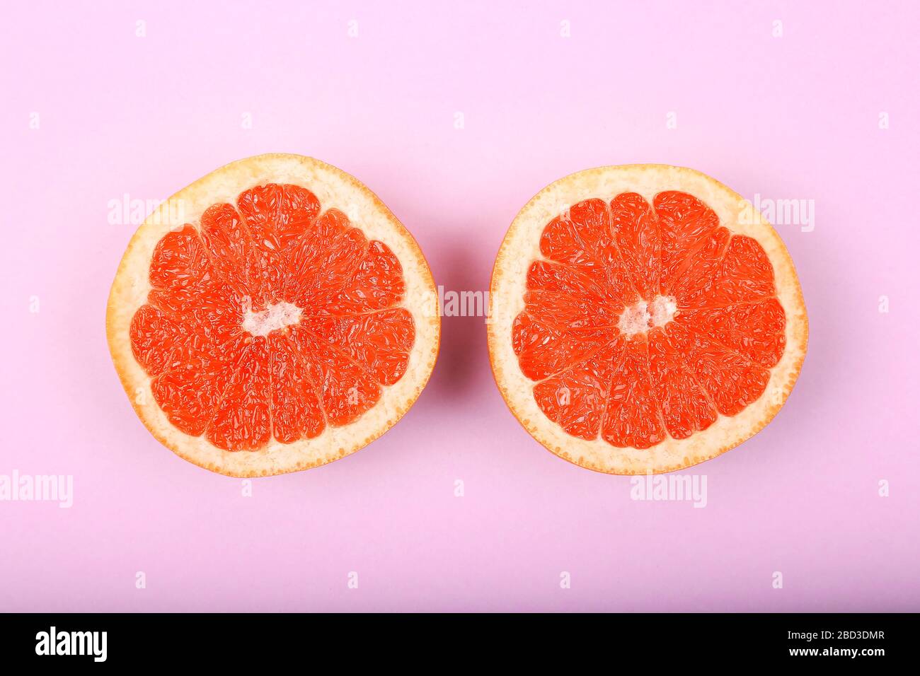 Fresh Red Grapefruit Slice On Blue Background Stock Photo