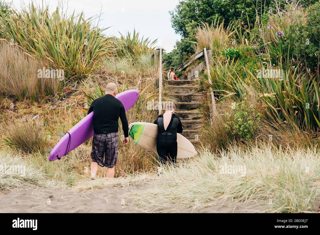 Family with surf and boogie boards leaving the beach Stock Photo Alamy