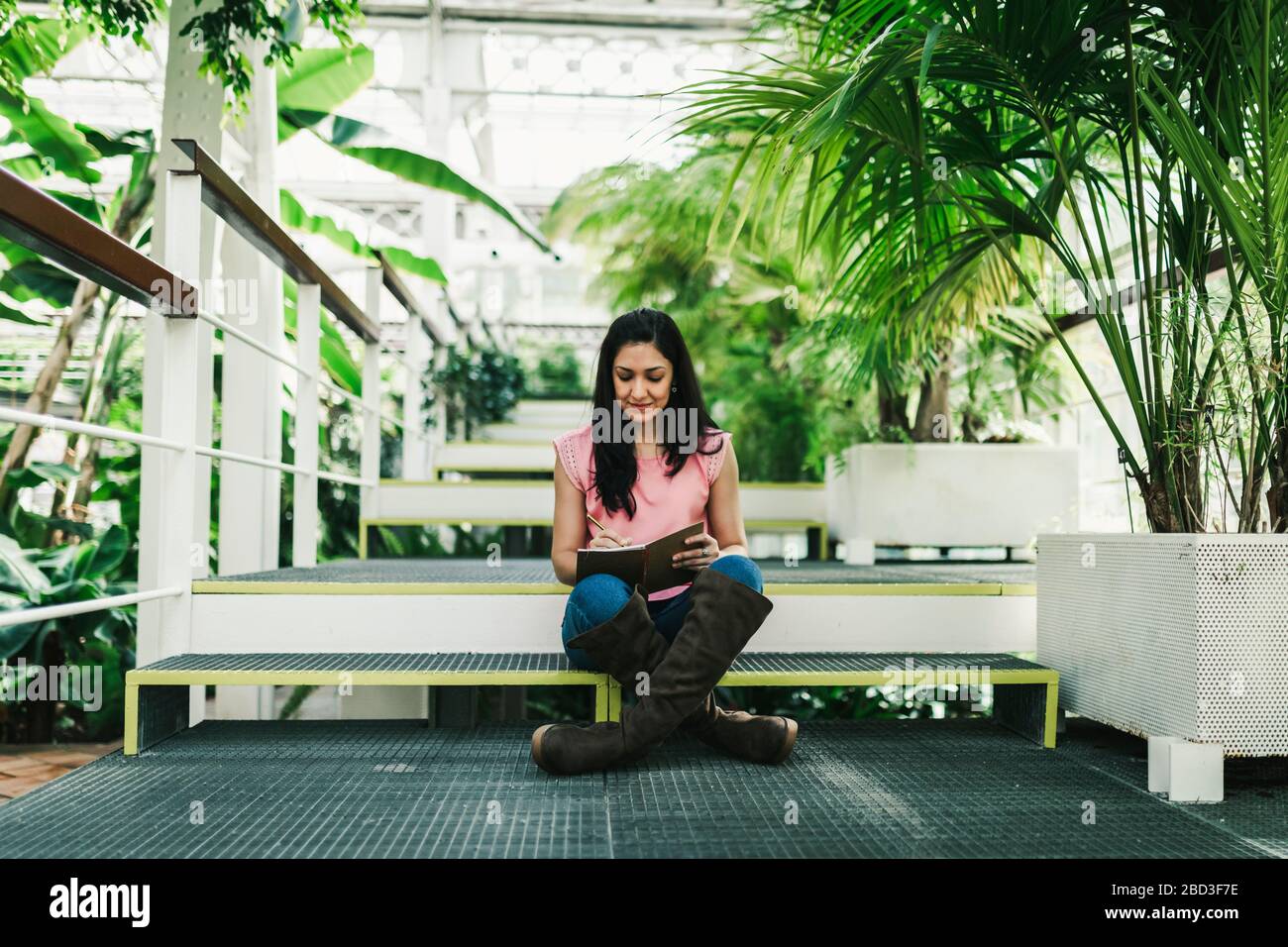 beautiful agronomical engineer taking notes in the greenhouse Stock Photo
