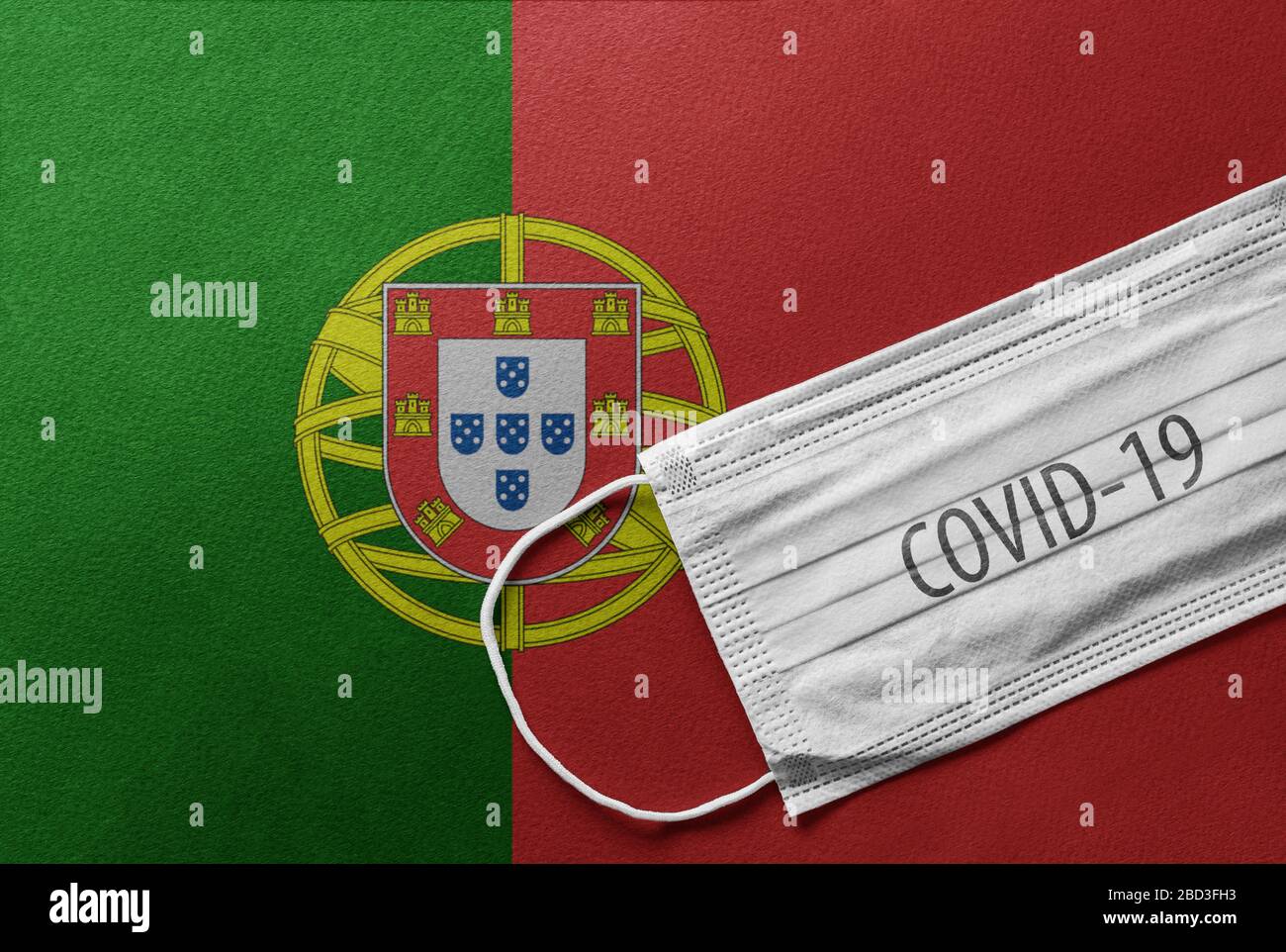 An individual face medical surgical mask on Portugal national flag