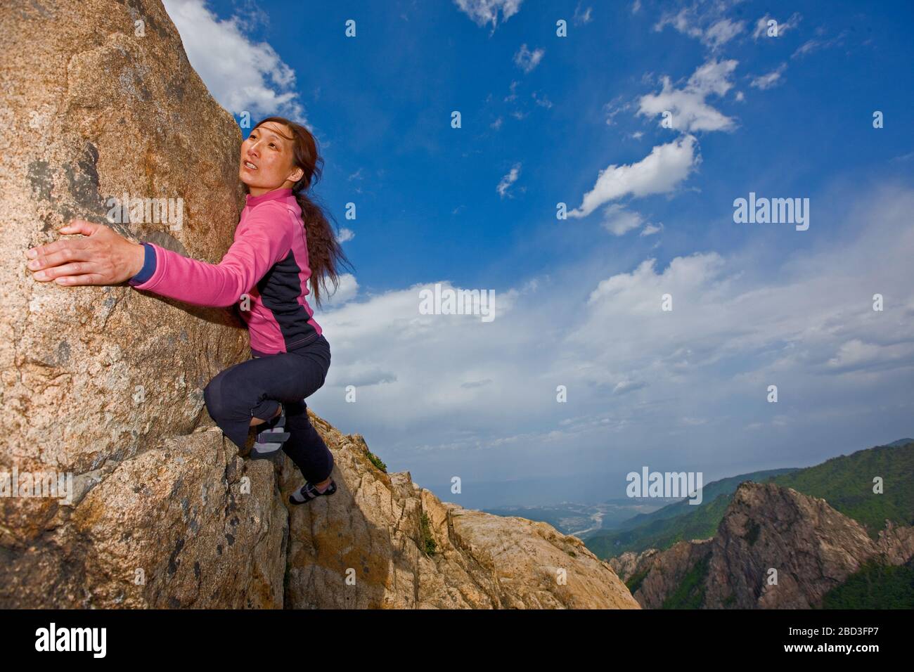 Female climber bouldering at Seroksan national park in South Korea Stock Photo
