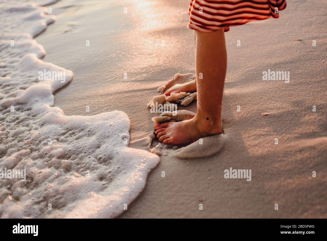 Burying her toes in the sand on the beach at Pensacola, Florida Stock ...