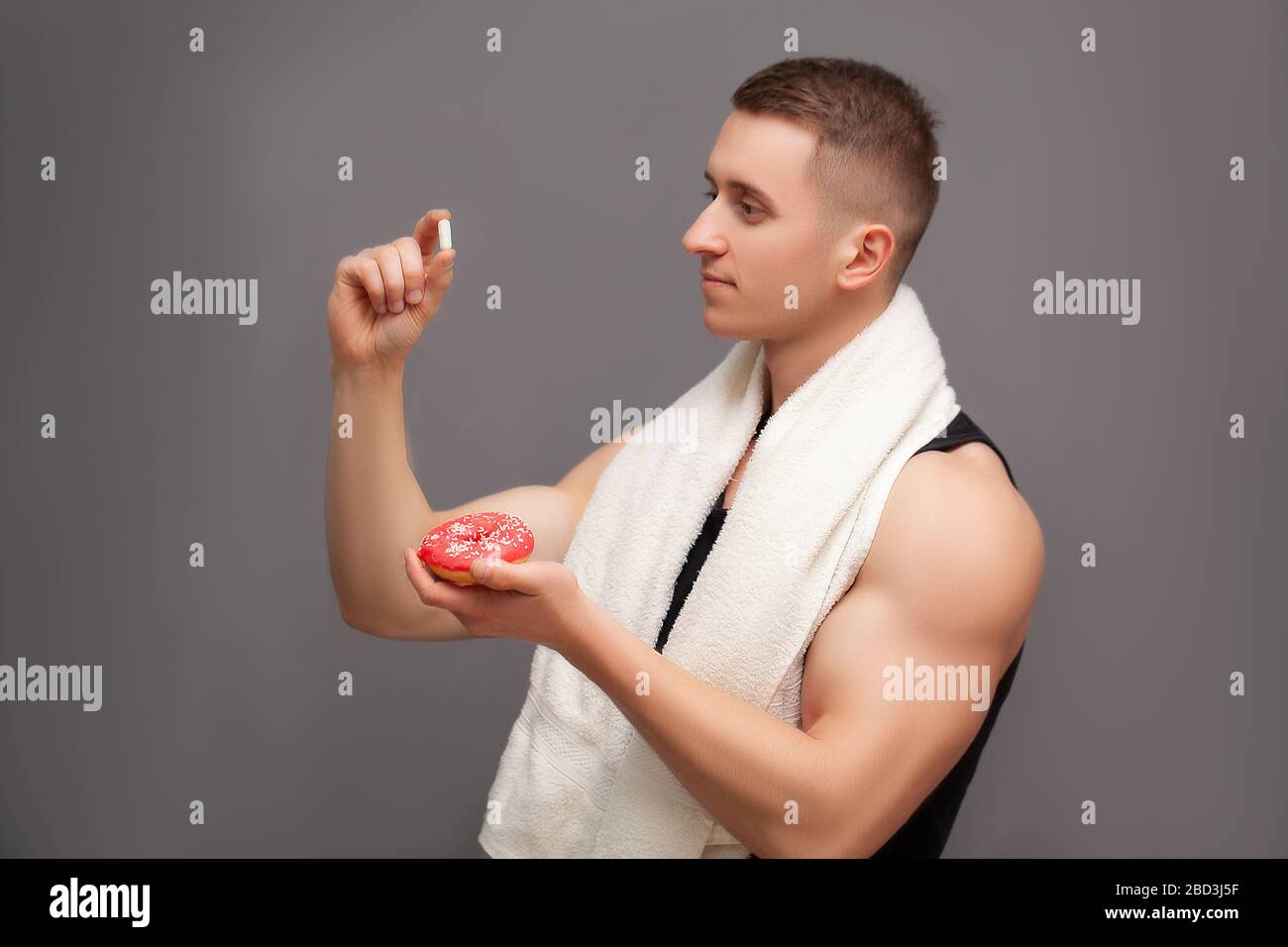 Trainer takes a pill of amino acids after training Stock Photo Alamy