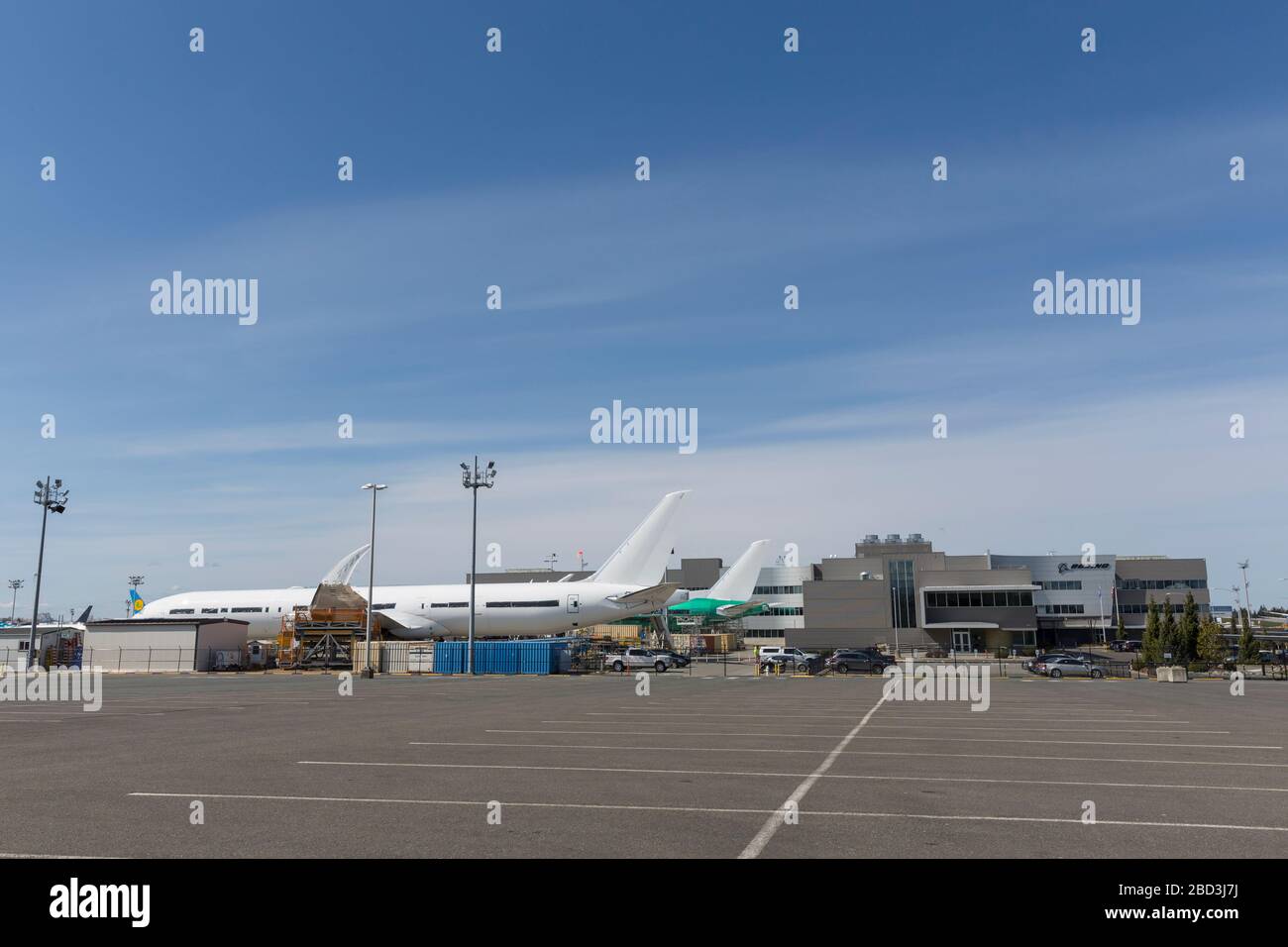 The Everett Delivery Center at the Boeing Factory sits idle in Everett, Washington on Monday, April 6, 2020. Boeing has extended the temporary suspension of production operations at all Puget Sound area and Moses Lake sites until further notice. The white airliner to the left is the 777X currently in flight test. Stock Photo